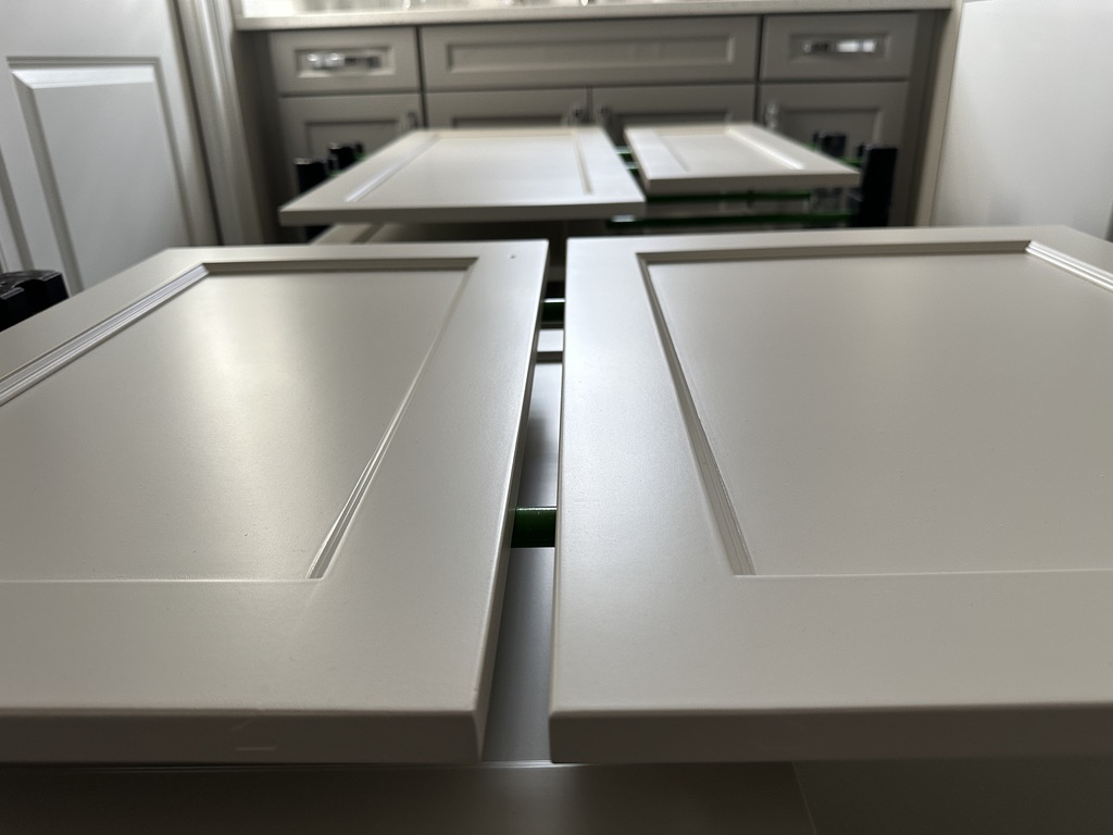 Kitchen cabinet doors prepped and laid out for painting by Sherwood Painting Services in Mooresville, NC.
