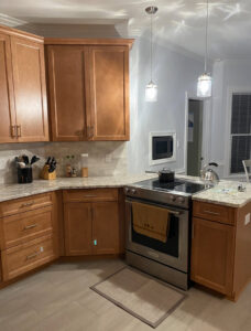 Kitchen with new wooden cabinets, countertops, and appliances installed by Berco Construction LLC in Godfrey, IL