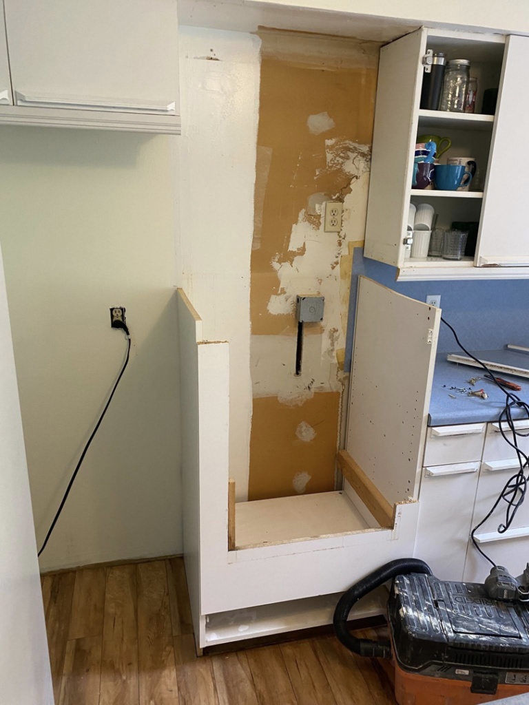 Installing new kitchen cabinets and working on electrical outlets during a remodel by Berg Handyman Services in Post Falls, ID