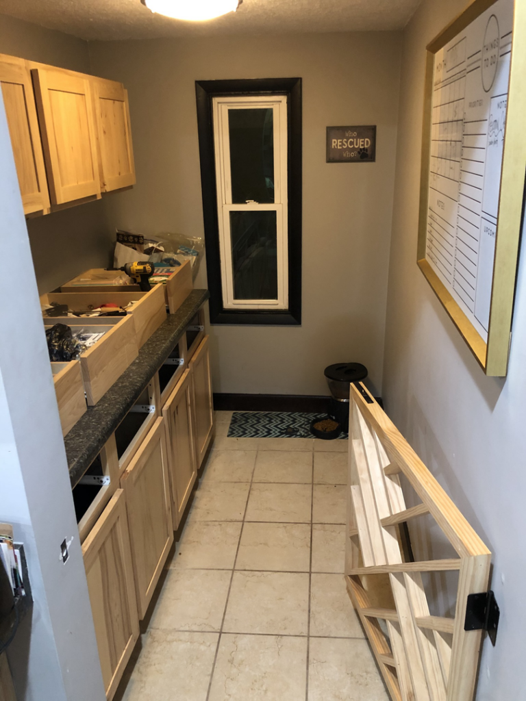 New kitchen cabinets being installed in a room by Elde Contracting in Saint Paul, MN.