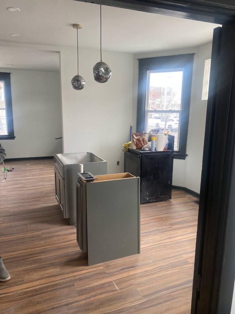 Kitchen cabinet installation in progress, showing base cabinets and a small refrigerator, by Enjaycee Unlimited in Cincinnati, OH.