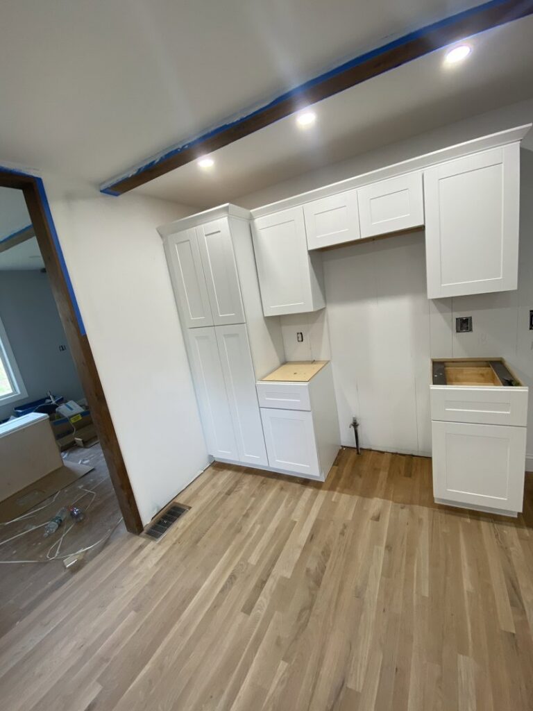 Kitchen cabinet installation in progress, showing new white cabinets installed by Amaro home improvement llc in Danbury, CT.