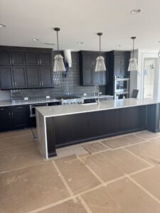 Kitchen cabinet installation in progress with protective floor covering by Contractor Kev LLC in Winston-Salem, NC