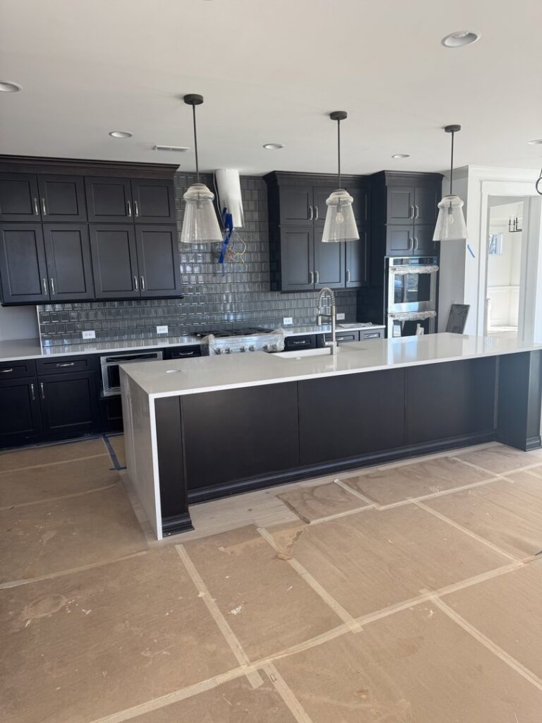 Kitchen cabinet installation in progress with protective floor covering by Contractor Kev LLC in Winston-Salem, NC