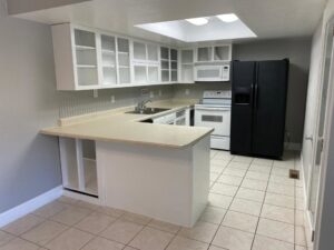 A newly installed kitchen with white cabinets and appliances by Prospective 1, LLC in Sparks, NV.