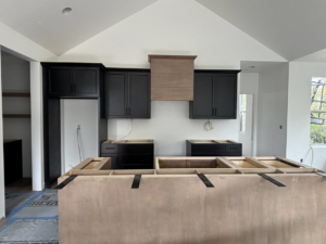 New kitchen cabinets being installed during a home renovation by Radue Homes in Green Bay, WI.