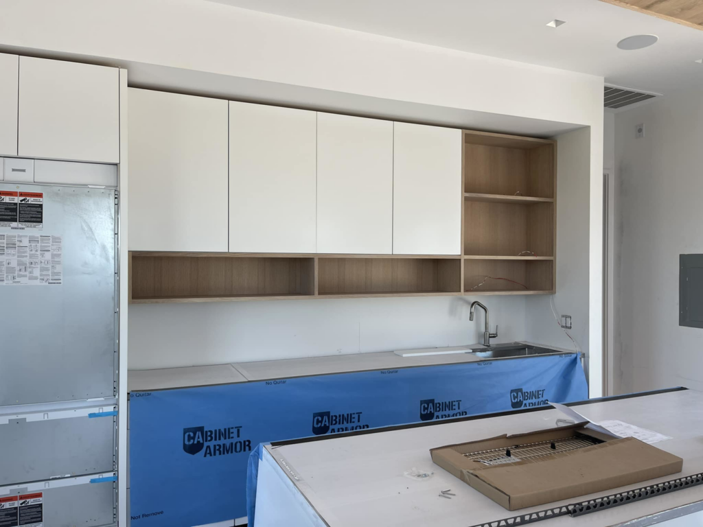 New kitchen cabinets and open shelving installed during a renovation project by Wanderworks in Charleston, SC.