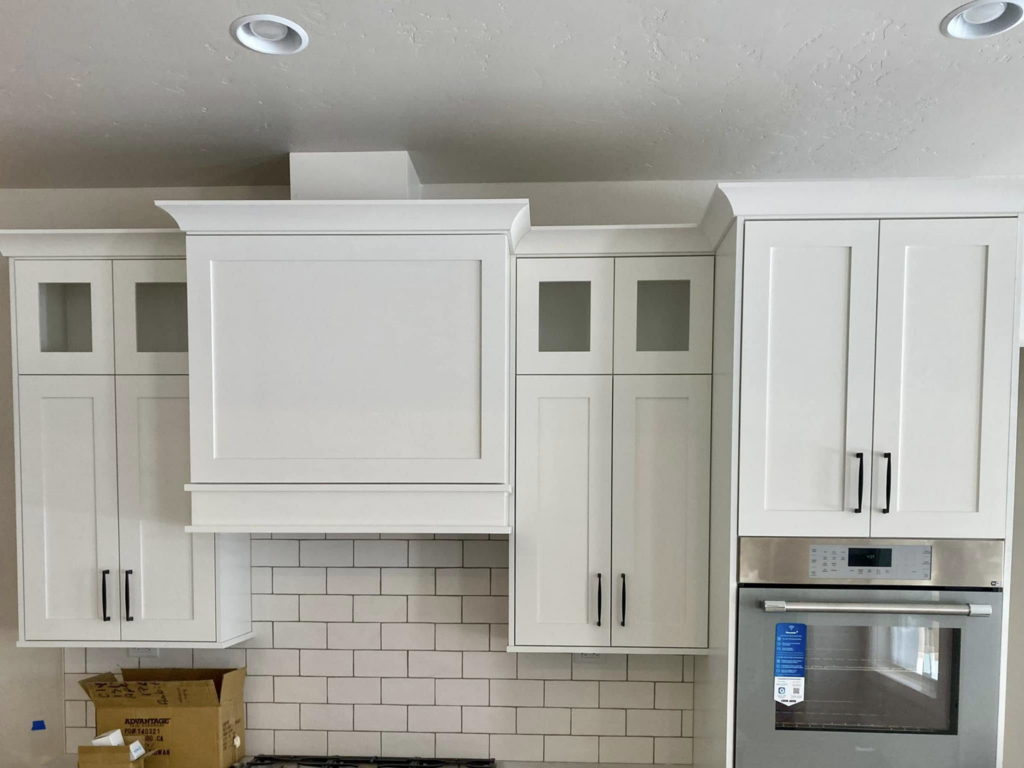 Newly installed white kitchen cabinets, subway tile backsplash, and oven, showcasing handyman kitchen remodeling by JMY Construction in Meridian, ID.