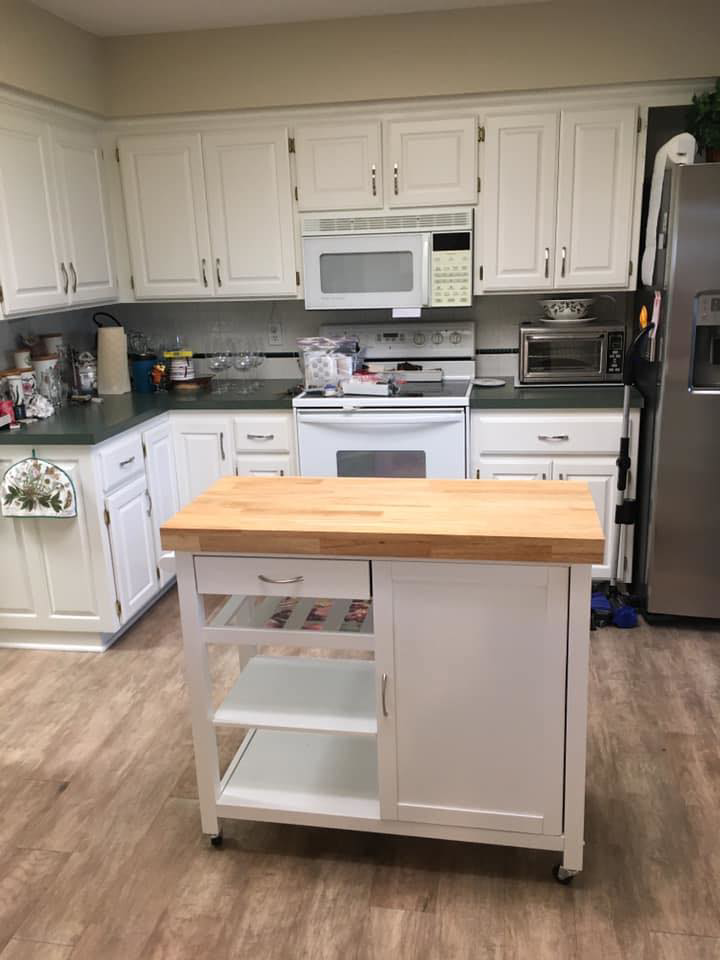 A newly installed kitchen island and white cabinets in a renovated kitchen by Calkins Cabinetry/Handyman's Services in Bentonville, AR.