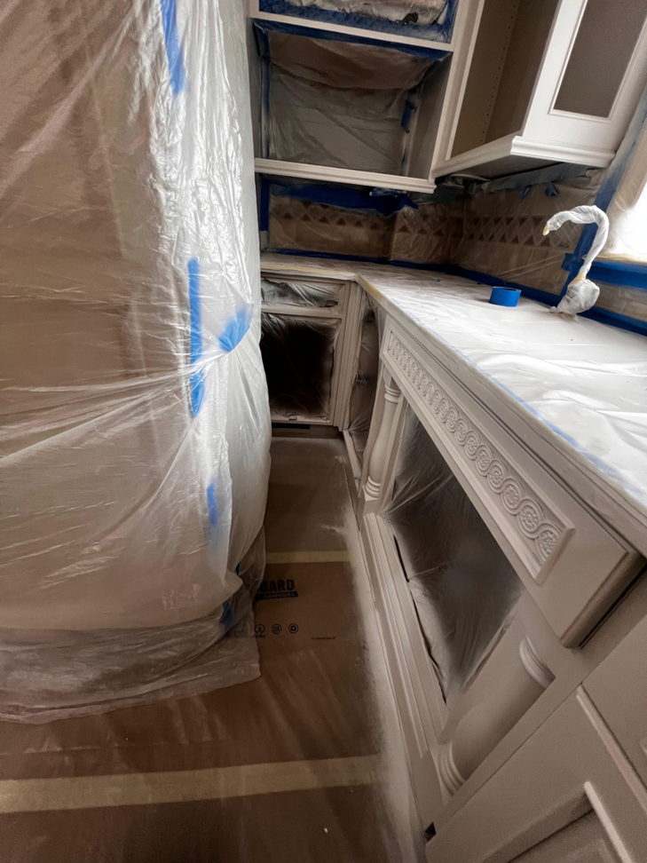 Kitchen cabinets and countertops protected for painting by GD Home Remodeling in Annadale, VA.