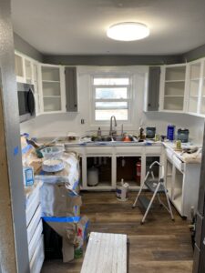Kitchen cabinet painting and renovation in progress by Iron Horse Handyman Services LLC in Laramie, WY.