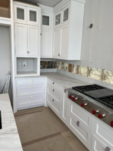 Kitchen cabinet and range installation in progress by Art of Stone Shop in Bridgeport, CT.
