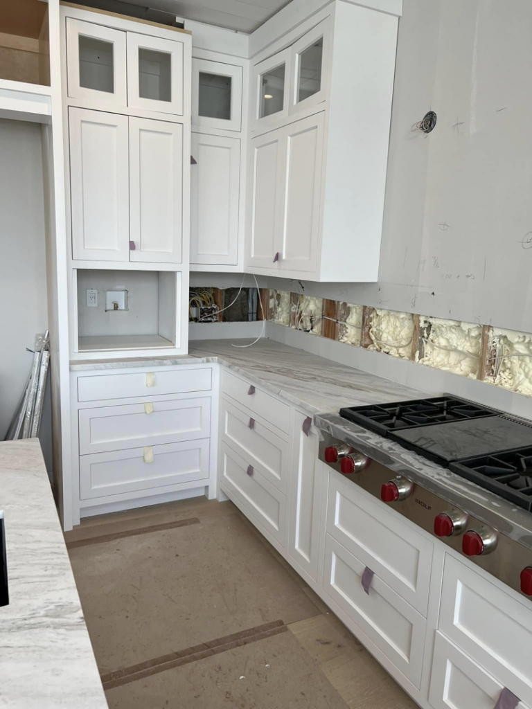 Kitchen cabinet and range installation in progress by Art of Stone Shop in Bridgeport, CT.