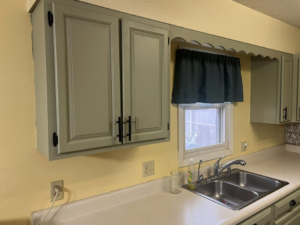Freshly painted kitchen cabinets and sink area by Halls Home Solutions in Pierre, SD