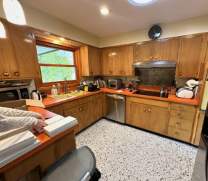 Kitchen cabinet refinishing in progress, showing old wood cabinets and new panels, by Cabinet Refinishing Northwest in Beaverton, OR.