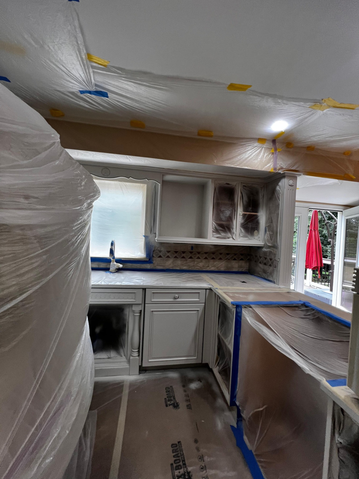 Kitchen cabinets and surfaces prepped for refinishing or painting by GD Home Remodeling in Annadale, VA.