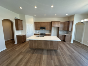 A newly installed kitchen with cabinets, sink, and microwave by Harpe Development LLC in Kenosha, WI.