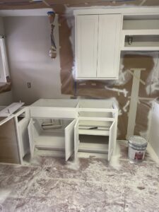 Kitchen cabinets being painted during a remodeling project by Coyote Restoration in North Richland Hills, TX.