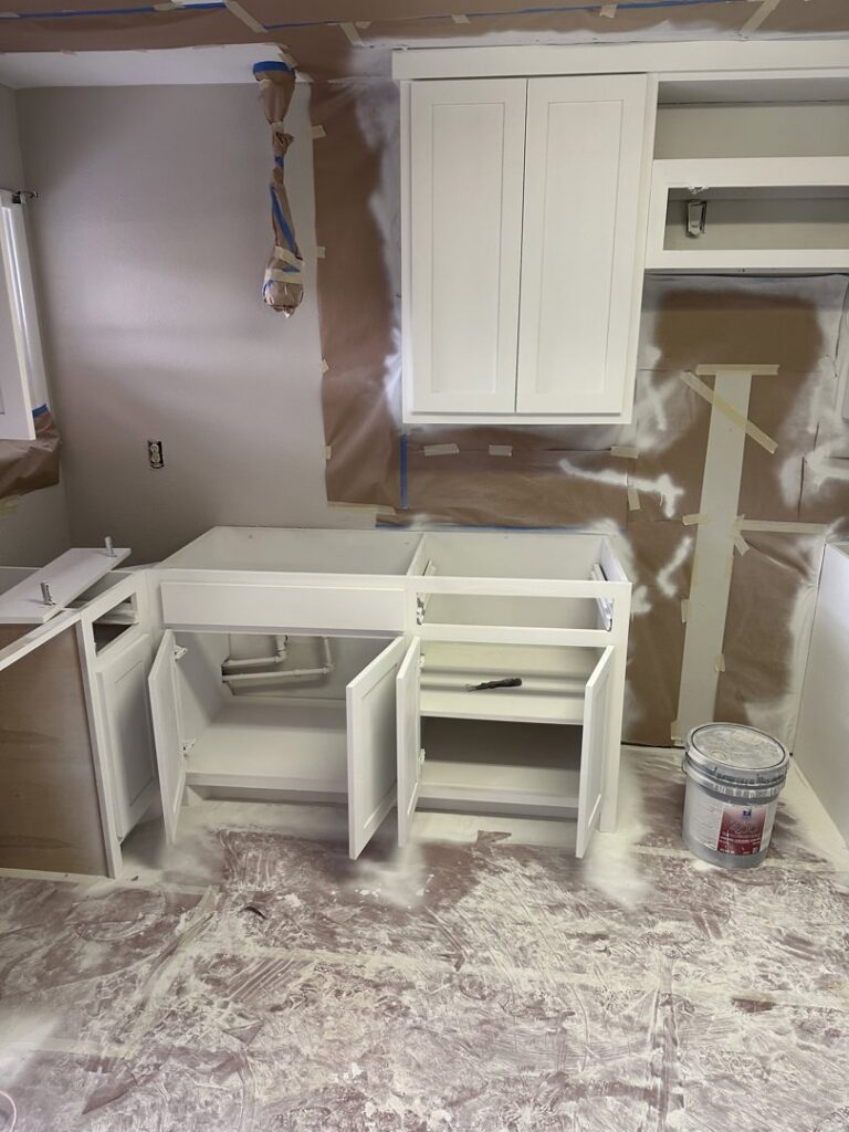Kitchen cabinets being painted during a remodeling project by Coyote Restoration in North Richland Hills, TX.