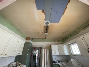 Damaged kitchen ceiling with exposed pipes and old light fixtures, ready for repair by JayBird Handyman Services in Benson, AZ
