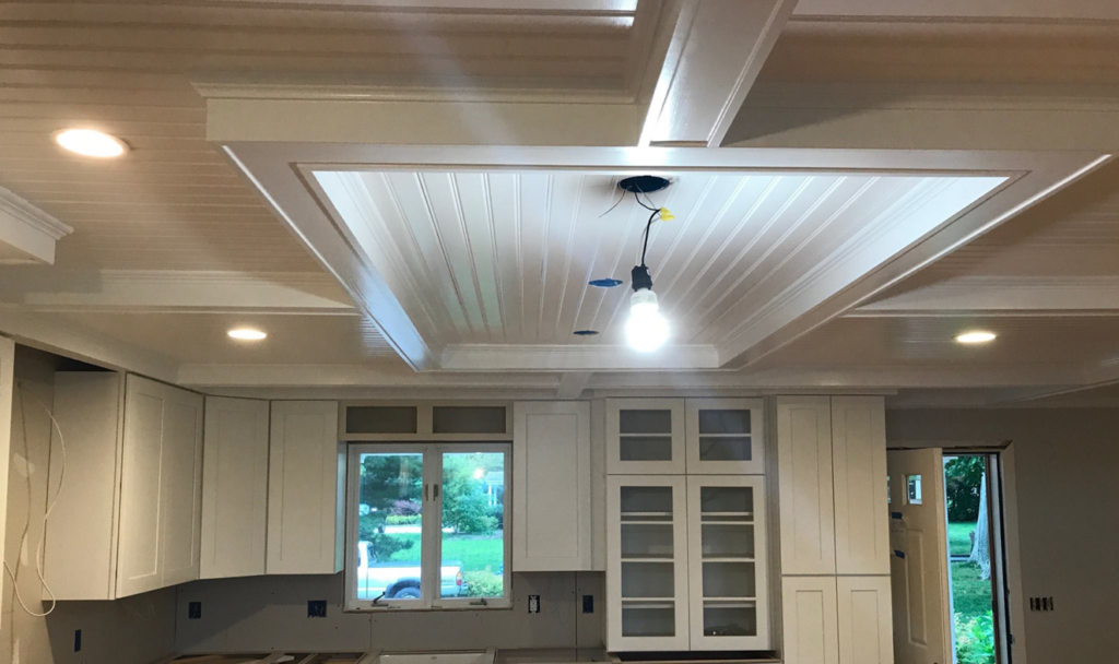 A newly installed kitchen ceiling with recessed lighting and decorative trim by Camelot Builders in Essex, CT.