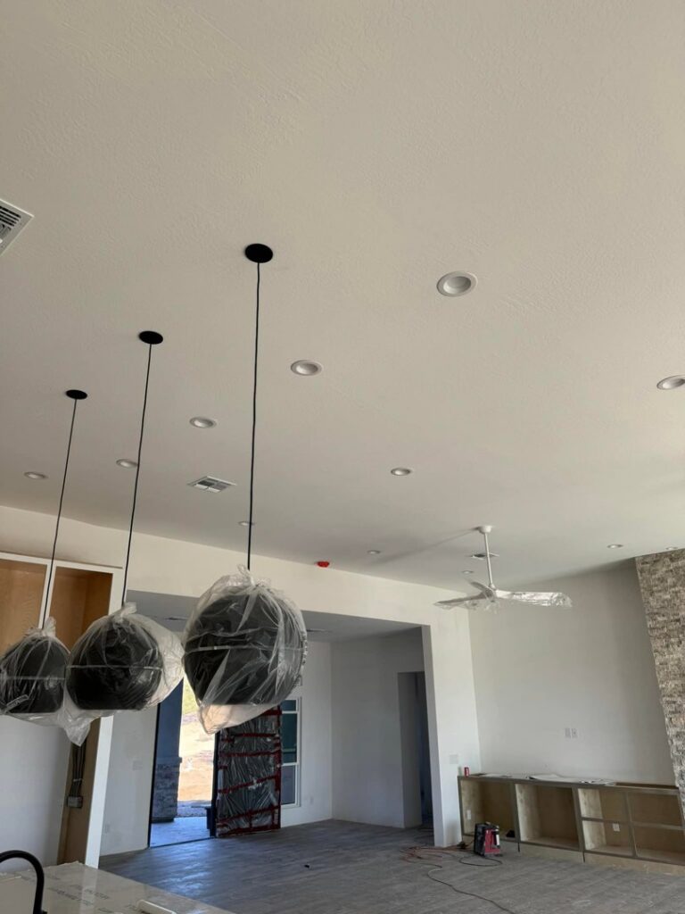 A kitchen ceiling with recessed lighting and pendant light fixtures, showing cabinet installation by Kelso Custom Builders, Inc. in Phoenix, AZ.