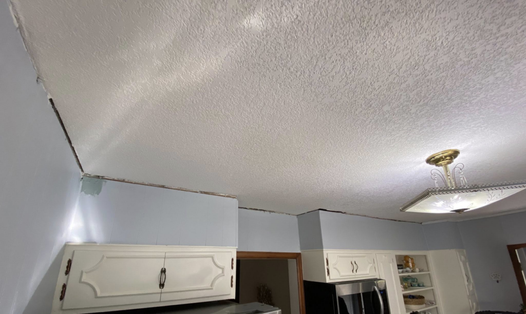 An unfinished kitchen ceiling and wall junction before trim installation by Blackbird Custom Carpentry in Kansas City, MO.