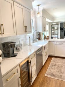 A kitchen featuring white cabinets, quartz countertops, and a dedicated coffee station by Cincinnati Cabinet Refacing in Cincinnati, OH.