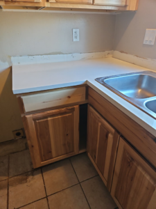 A newly installed kitchen counter, sink, and cabinets by Pro Helping Hands Renovation in Colorado Springs, CO.