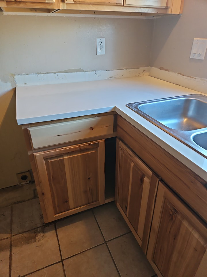 A newly installed kitchen counter, sink, and cabinets by Pro Helping Hands Renovation in Colorado Springs, CO.