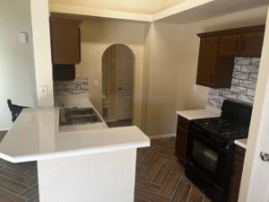 A kitchen remodel featuring new white countertops and a stylish black and white backsplash by Lay's Remodeling LLC in El Paso, TX