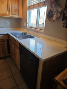 A new kitchen countertop and dishwasher installation by Pro Helping Hands Renovation in Colorado Springs, CO.