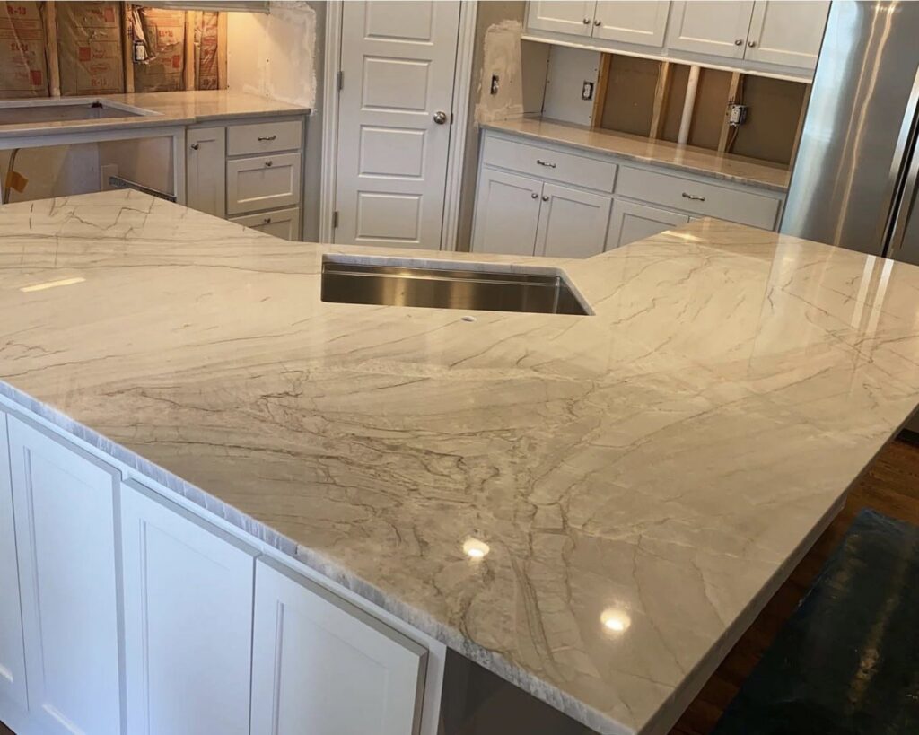 Kitchen countertop installation in progress, showing a large island with a sink cutout by Javier's Countertops in Springdale, AR