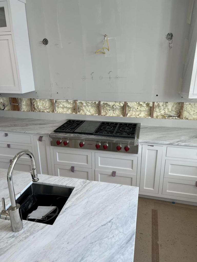 Kitchen countertop and sink installation in progress by Art of Stone Shop in Bridgeport, CT.