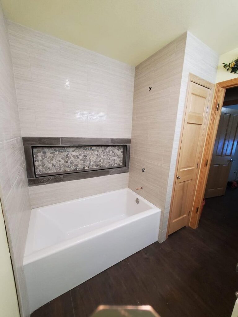 A renovated kitchen featuring new countertops and a light-colored backsplash by CSR Tile Construction LLC in Minneapolis, MN.
