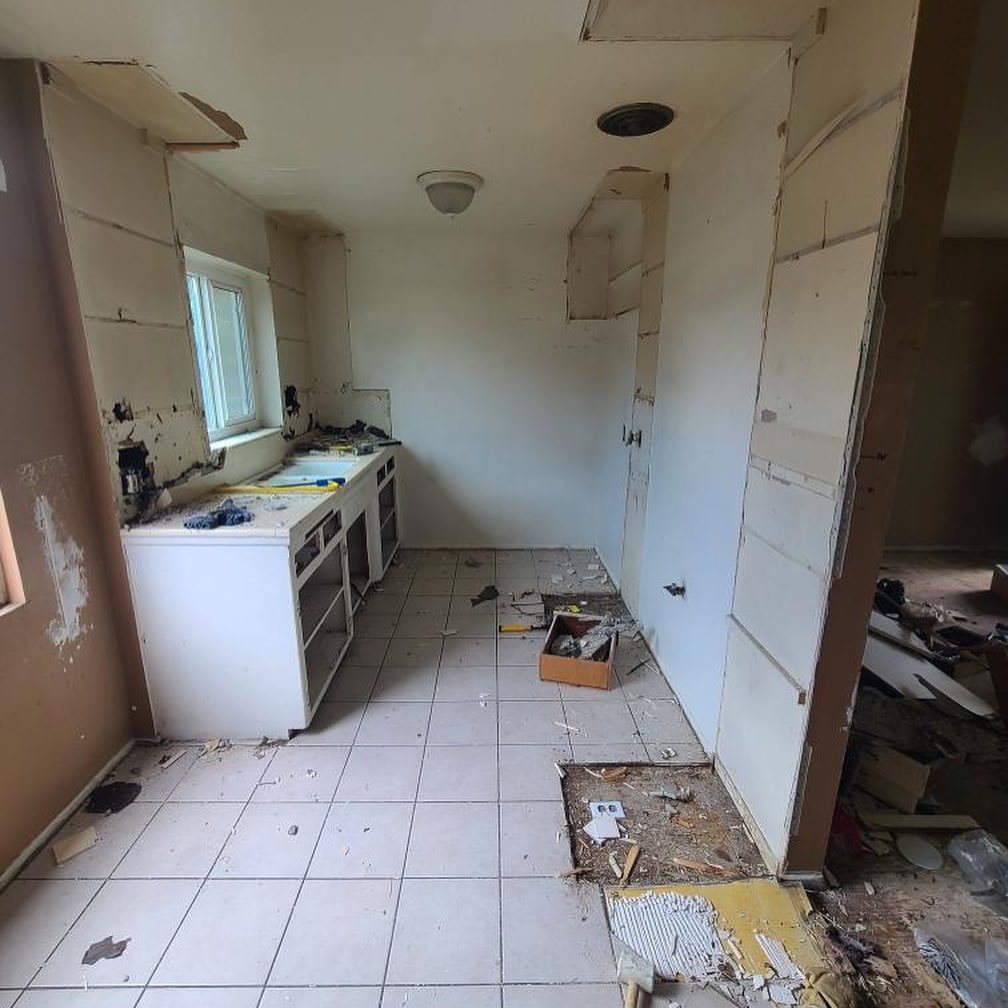 A kitchen undergoing demolition with removed cabinets and exposed walls by Premier Home Services in Fullerton, CA