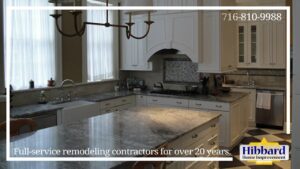 A renovated kitchen and dining area featuring light wood cabinets and a breakfast bar by Hibbard Home Improvement in Williamsville, NY.