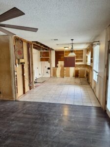 Kitchen and dining area structural renovation by Load Bearing Wall Pros in Plano, TX, with new beam and open space.