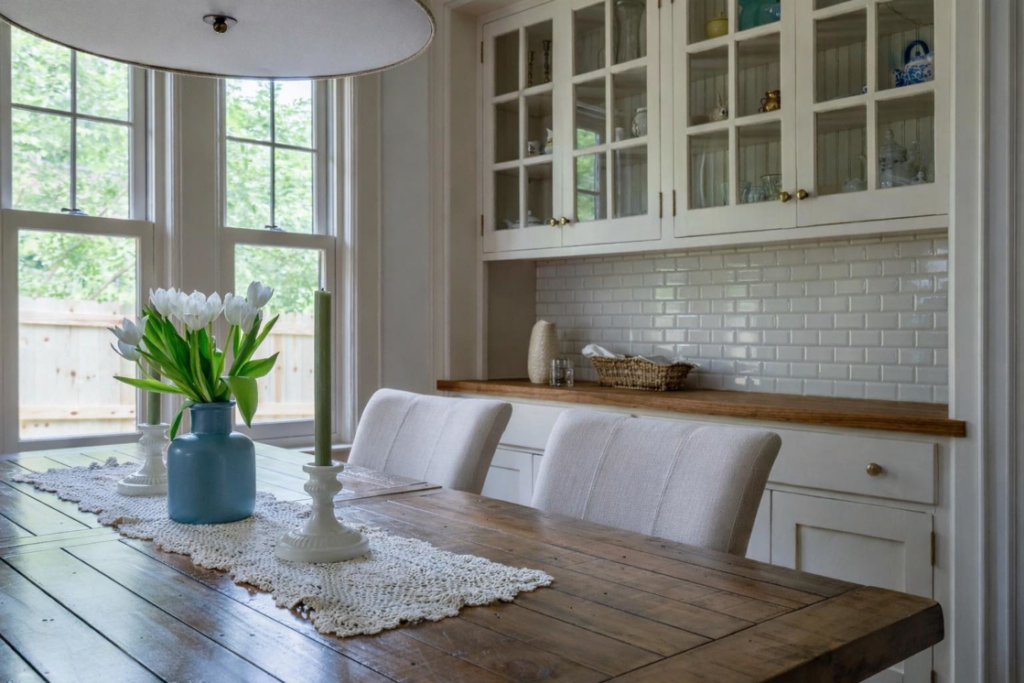 Built-in white cabinets with glass doors and a subway tile backsplash installed by Kyle Build in Chattanooga, TN.