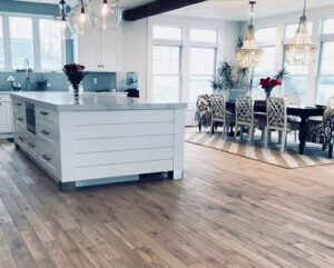 Modern kitchen and dining area with light hardwood floors by Diamond Flooring LLC in Boston, MA
