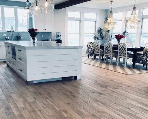 Modern kitchen and dining area with light hardwood floors by Diamond Flooring LLC in Boston, MA
