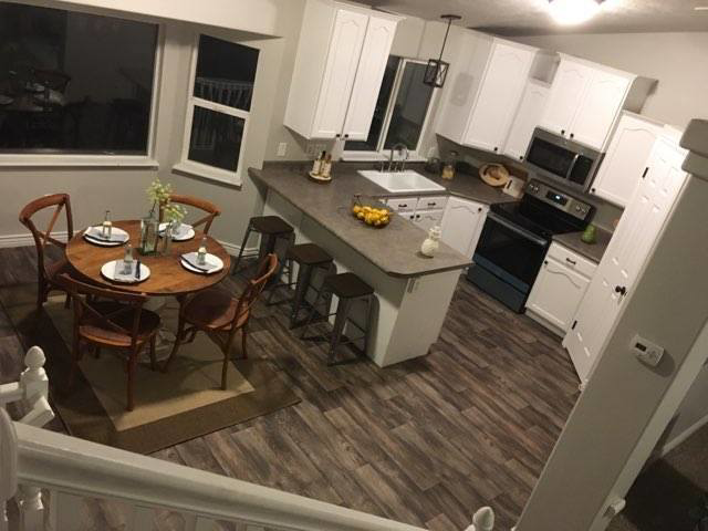 A newly remodeled kitchen and dining room with modern finishes by J & D Home Innovations in West Jordan, UT