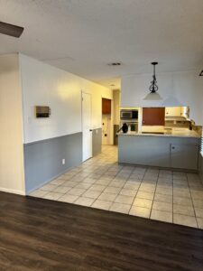 Kitchen and dining area with a wall removed and new support beam installed by Load Bearing Wall Pros in Plano, TX.