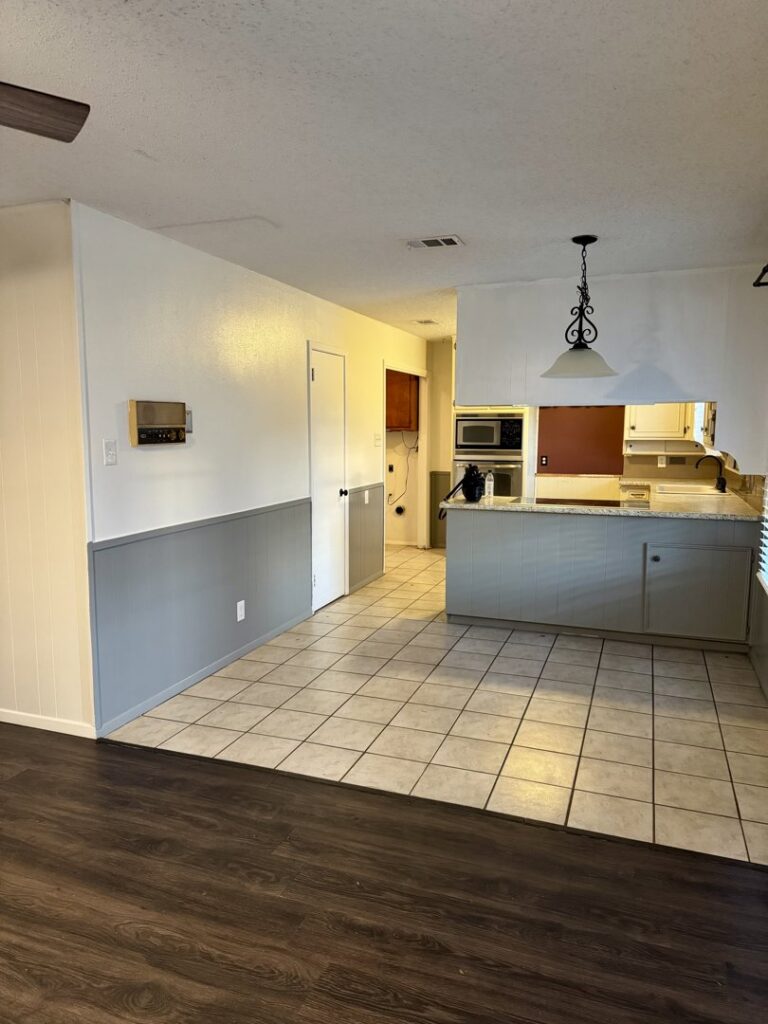 Kitchen and dining area with a wall removed and new support beam installed by Load Bearing Wall Pros in Plano, TX.