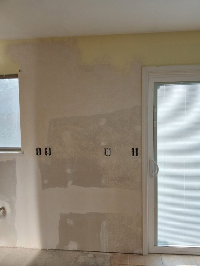 Kitchen wall with new drywall and mudding during renovation by Cal Heights Construction And Handyman Services in Bakersfield, CA