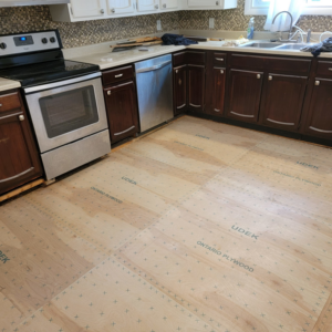 New plywood subflooring installed in a kitchen, ready for final flooring, by Jonny Hinton - Handyman Extraordinaire in Colorado Springs, CO.