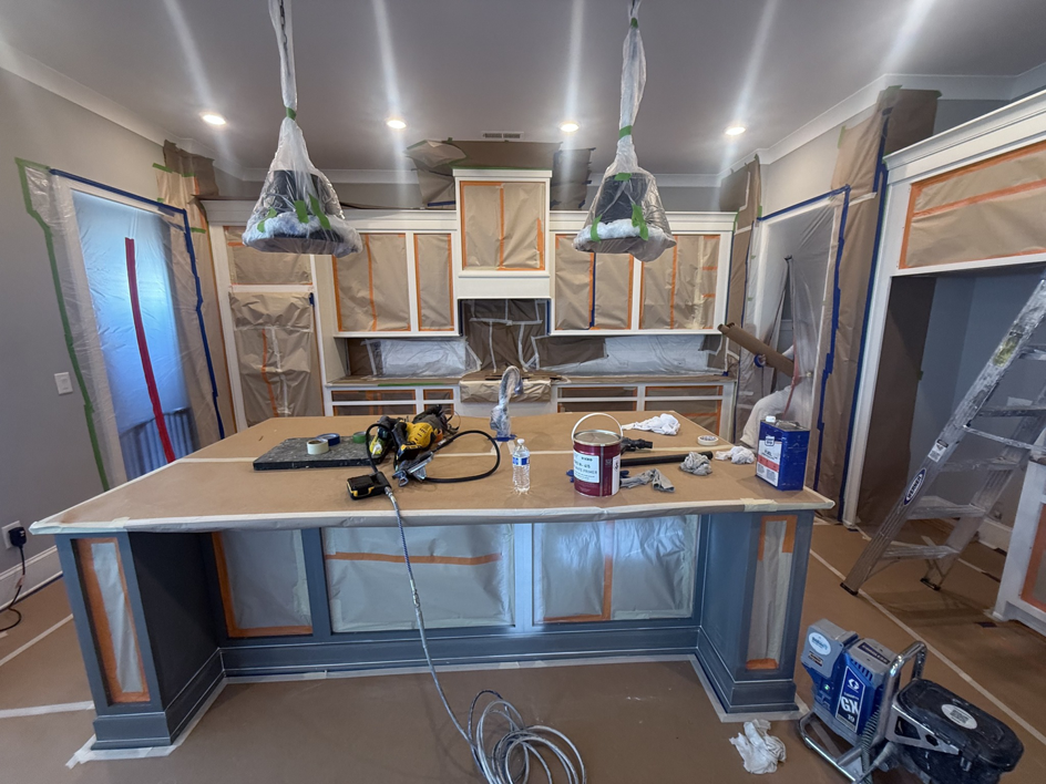 A kitchen fully prepped and taped off for painting by Sherwood Painting Services in Mooresville, NC.