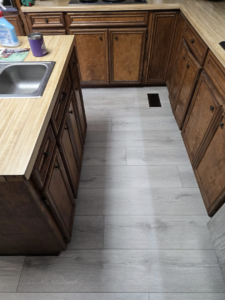 Newly installed light hardwood flooring in a kitchen by Refined Hardwood Flooring LLC in Wilmington, NC