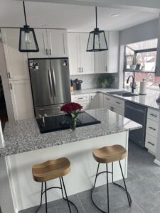 A remodeled kitchen showcasing a large island with a stovetop and new appliances by Advanced Remodeling Services in Elbert, CO.