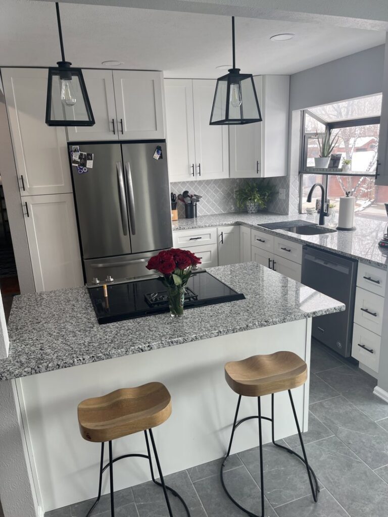 A remodeled kitchen showcasing a large island with a stovetop and new appliances by Advanced Remodeling Services in Elbert, CO.